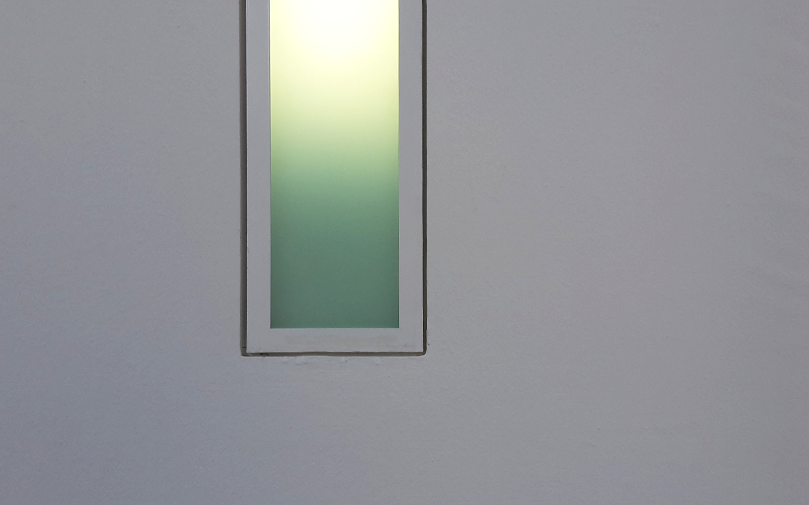 photograph of a wall light showing a color gradient