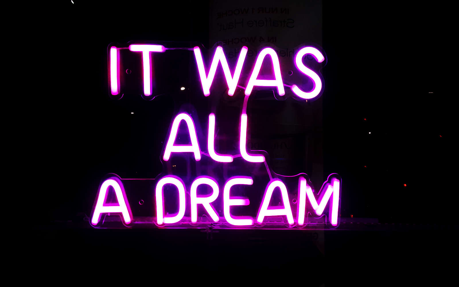 photograph of a neon sign saying \'it was all a dream \'